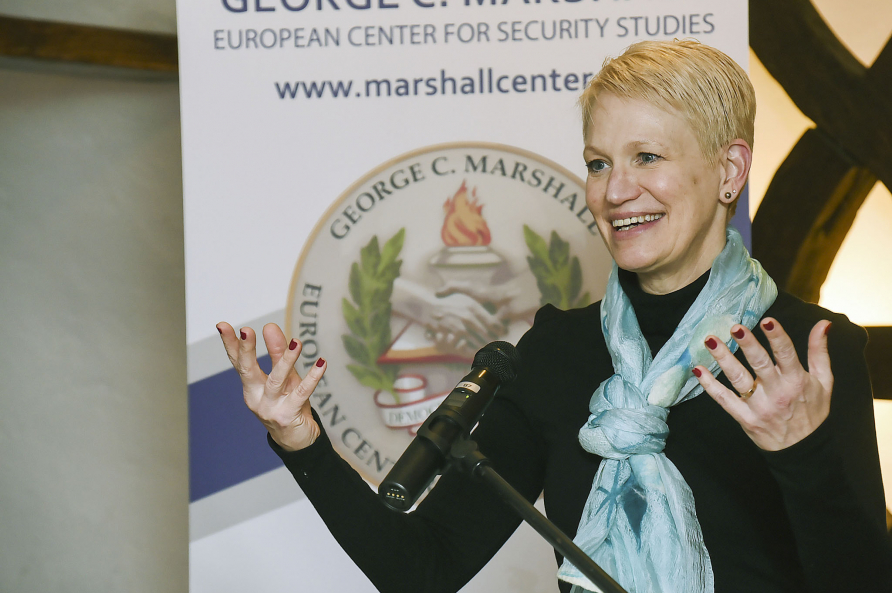 A femal participant speaking at the podium during the European security seminar.